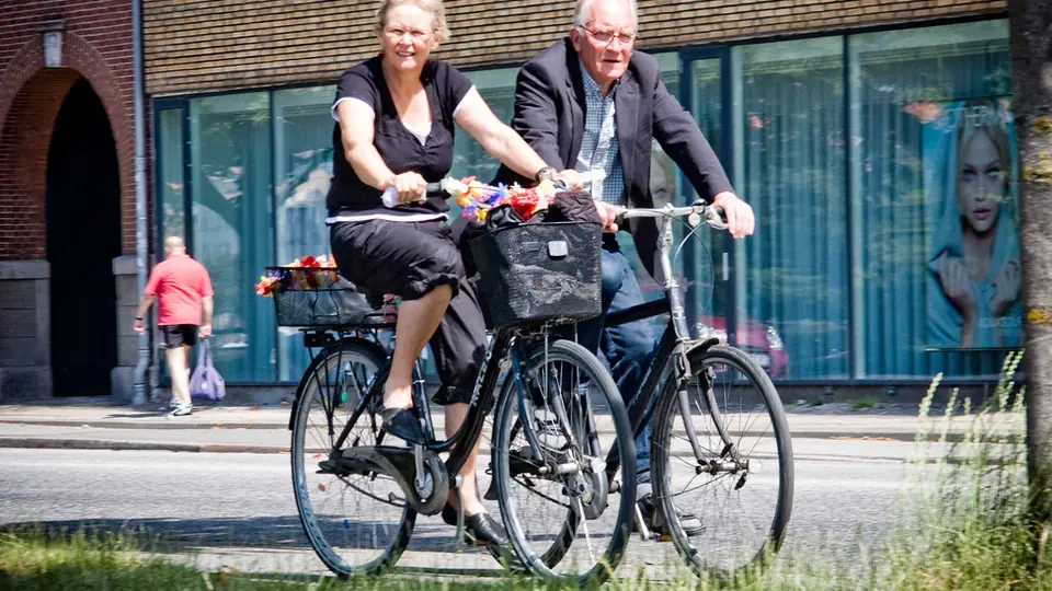 Datingsites voor 50-plussers: een ouder koppel fietst samen door de stad